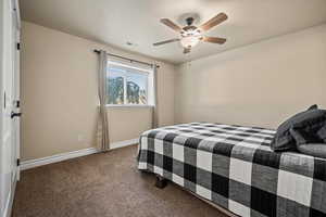 Carpeted bedroom with ceiling fan