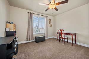 Office area featuring carpet floors and ceiling fan