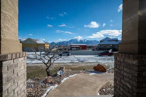 Yard covered in snow with a mountain view