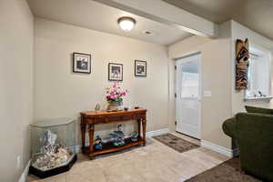 Entrance foyer with light tile patterned flooring