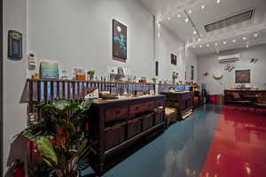 Interior space with concrete floors and a wall mounted air conditioner