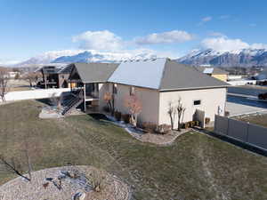 View of property exterior featuring a mountain view and a yard