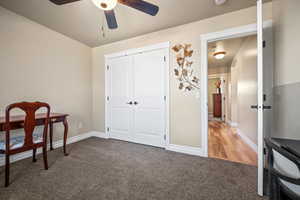 Office with ceiling fan and carpet floors