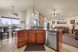 Kitchen featuring a center island, dishwasher, sink, and pendant lighting