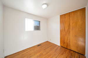 Unfurnished bedroom with hardwood flooring