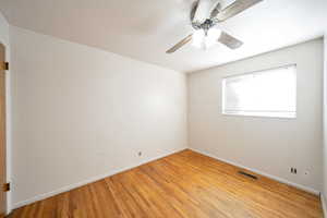 Unfurnished room featuring ceiling fan and light hardwood