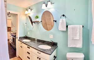 Bathroom featuring toilet, vanity, and tile patterned flooring