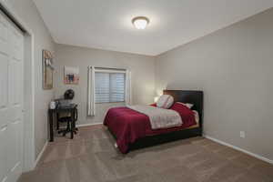 Bedroom featuring carpet and a closet