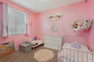 Bedroom featuring light carpet