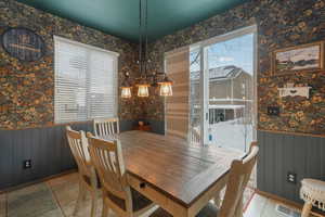 Dining space with plenty of natural light and a notable chandelier