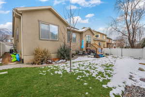 Snow covered property with a yard