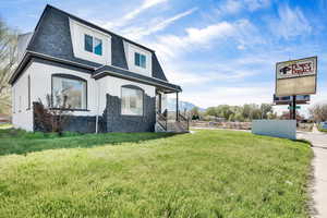 View of front of property with a front lawn and a mountain view