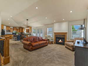 Living room with light carpet and lofted ceiling