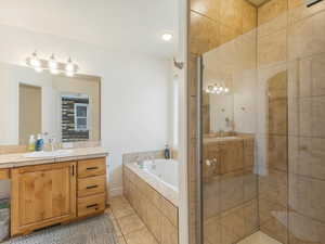 Bathroom featuring vanity, independent shower and bath, and tile patterned floors