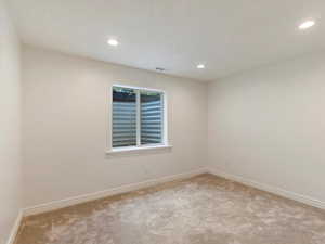 Empty room with light colored carpet