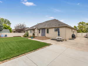 Rear view of property featuring a patio area and a yard