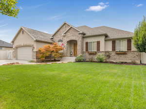 View of front of home featuring a garage and a front yard