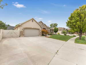 View of front of home with a front lawn and a garage