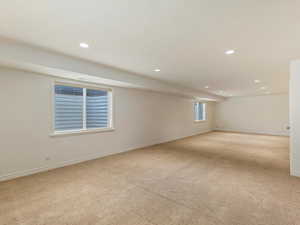 Basement with light colored carpet