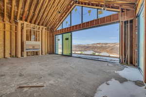 Misc room with a mountain view and high vaulted ceiling