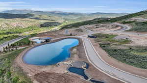 View of pool with a water and mountain view