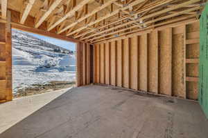 Snow covered garage with a mountain view