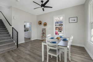 Dining area with ceiling fan and hardwood / wood-style floors