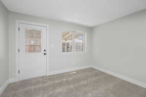 View of carpeted entrance foyer