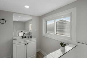 Bathroom featuring wood-type flooring and vanity