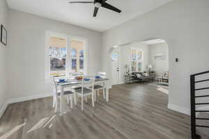 Dining area with ceiling fan and hardwood / wood-style flooring