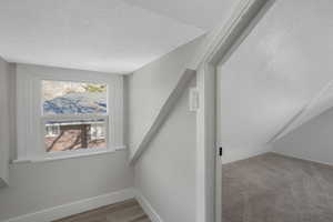 Staircase featuring a textured ceiling