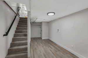 Stairs with hardwood / wood-style flooring