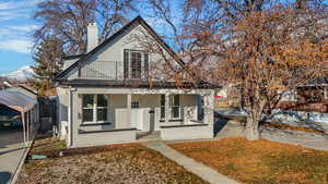 View of front of property featuring central AC unit, covered porch, and a balcony