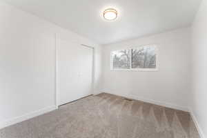 Unfurnished bedroom with a closet and carpet flooring