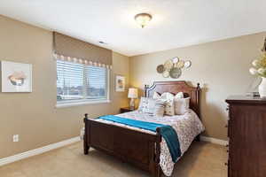 Bedroom #3 featuring light colored carpet