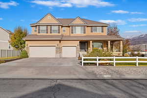 View of front of house featuring a mountain view and a garage