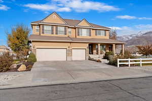 View of front of house featuring a mountain view and a garage