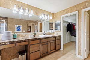 Primary suite bathroom #1 with tile patterned flooring and vanity