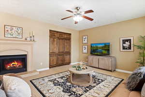 Family room with light carpet and ceiling fan