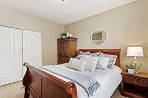 Main level carpeted bedroom with a closet