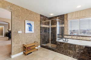 Primary suite bathroom #1 featuring shower with separate bathtub