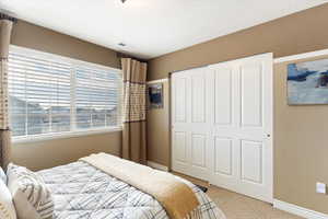 Carpeted bedroom #5 featuring a closet