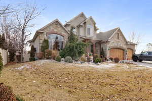 View of front of home with a garage and a front yard