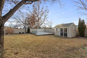 View of yard with a patio area and a storage unit