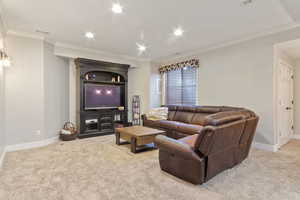 Carpeted living room featuring crown molding