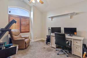 Office with light carpet, ceiling fan, and lofted ceiling