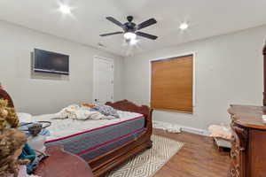 Bedroom featuring ceiling fan and hardwood / wood-style flooring