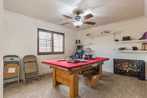 Game room with ceiling fan, carpet flooring, and crown molding