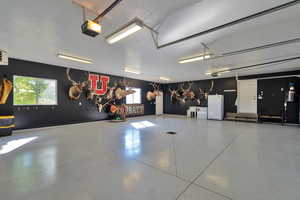 Garage with white fridge and a garage door opener