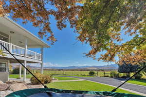 View of yard featuring a balcony, a mountain view, and a rural view